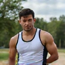 Close-up portrait of David Lee, a male client of NutriLife Indonesia, looking fit and confident, exercising outdoors.